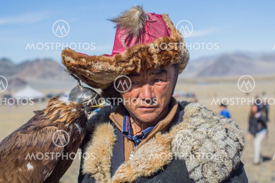 Kazakh Golden Eagle Hunter at traditional clothing, during annual national competition with birds of prey "Berkutchi" of West Mongolia.