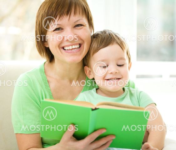 Mother is reading book for her son
