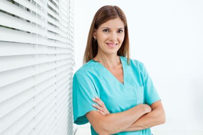 Confident Female Dentist In Clinic