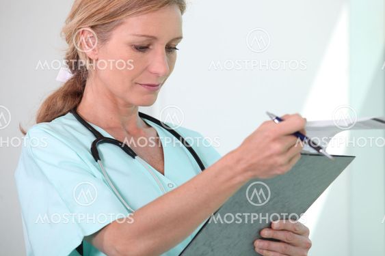 Blond female nurse holding clipboard