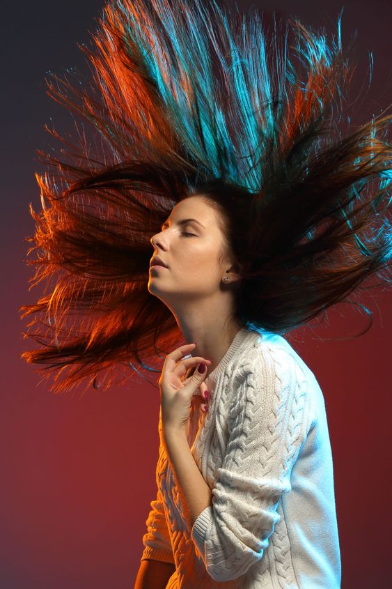 Trendy hairstyle concept. Young woman with colorful dyed...