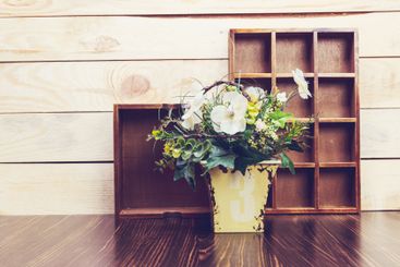 Cozy pastel wooden home decor objects on blue background