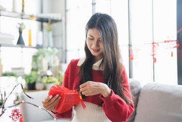 Asian Woman decorated house for Chinese New Year...