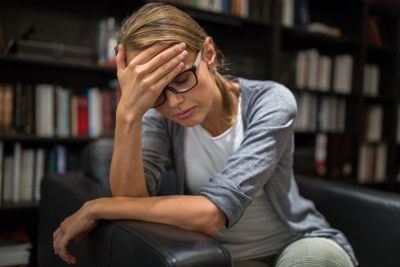 Woman suffering from depression Sitting in a chair...