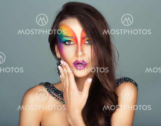 Portrait of a young beautiful girl with a fashion bright multicolored makeup