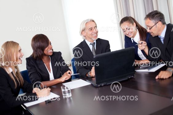 Happy mature business manager with his team