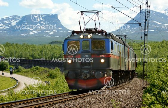 Iron ore freight trains crossing the Abisko village in the background with Patch