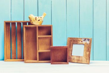 Cozy pastel wooden home decor objects on blue background