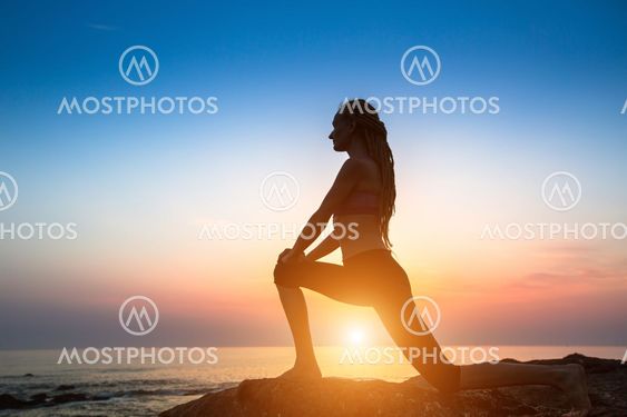 Silhouette fitness yoga women on the coast