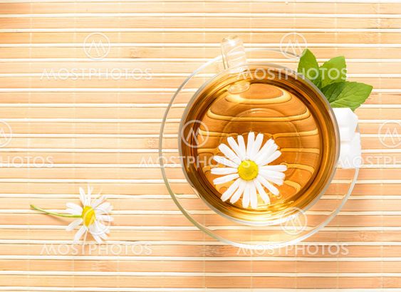 teacup with herbal chamomile tea