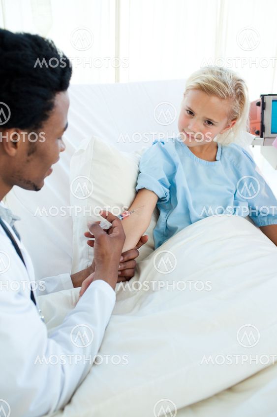 Male doctor giving a child patient an injection