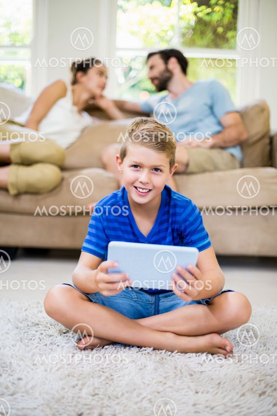 Portrait of boy using a digital tablet in living room