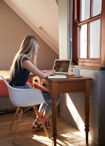 Young female working from home on laptop