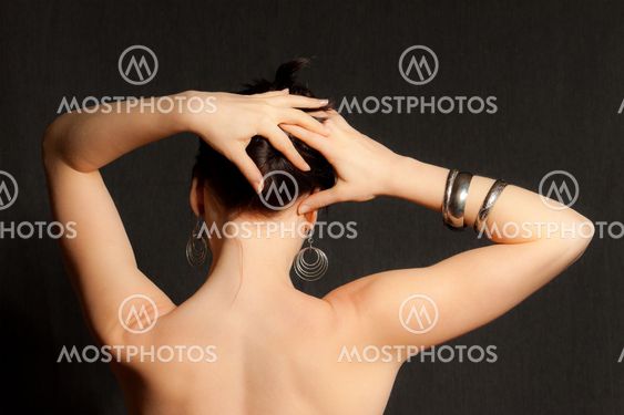 Woman's back with her hand on the head
