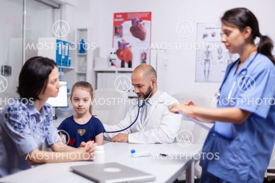 Doctor pediatry checking evolution of flu using stethoscope