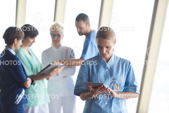 female doctor with tablet computer standing in front of...