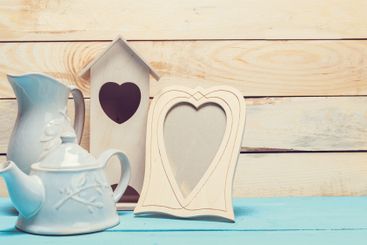 Cozy pastel wooden home decor objects on blue background