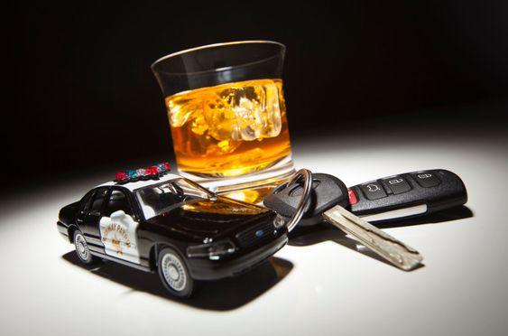 Highway Patrol Police Car Next to Alcoholic Drink and Keys