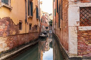 Traditional narrow romantic canal with old houses in...