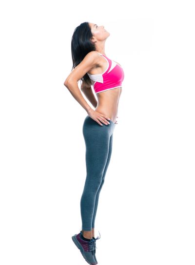 Full length portrait of a fitness woman stretching 