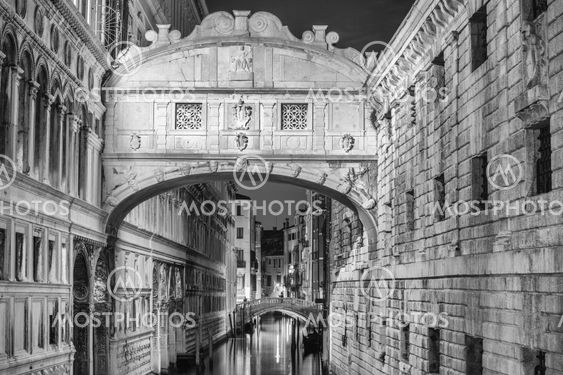 VENICE, ITALY - MAR 23, 2014: Bridge of Sighs at night with tourists. The city has 21 million visitors each year