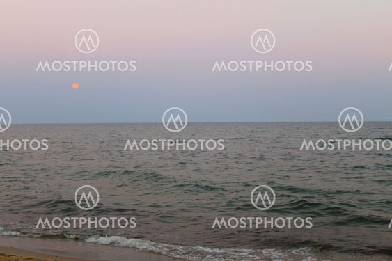 Full moon rising over the sea