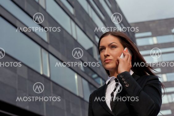 Beautiful business woman on the phone at modern building