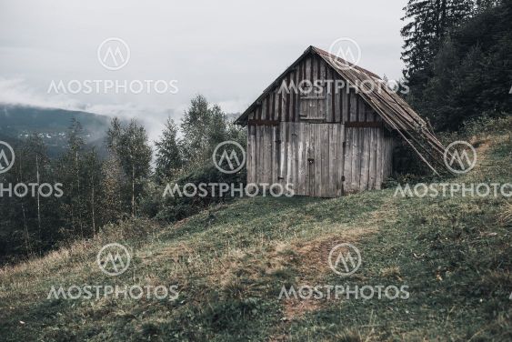 gray wooden house with boards in the Carpathian...