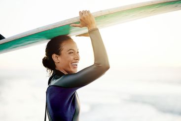 Laughing, surfer or happy woman at sea for fitness...