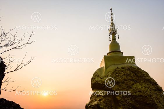 pagoda on rock stone and sunset time
