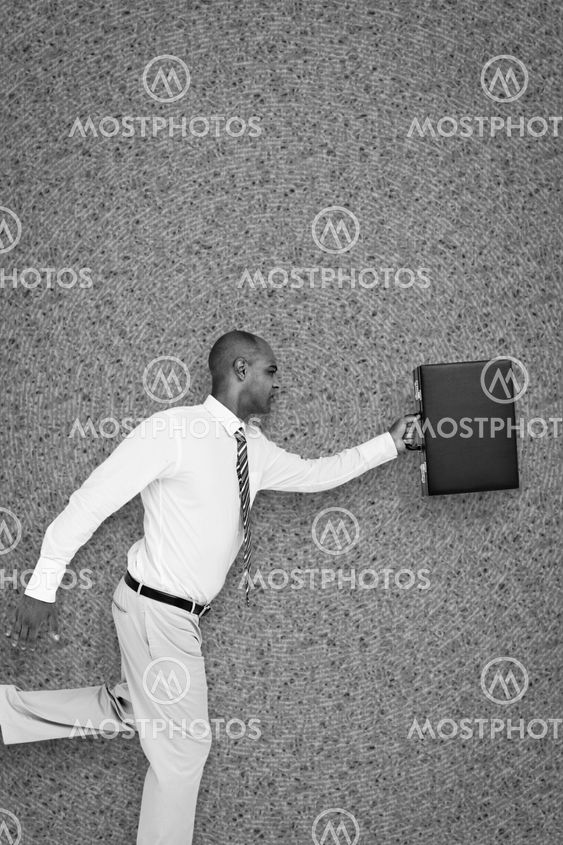 Composite image of businessman running with briefcase