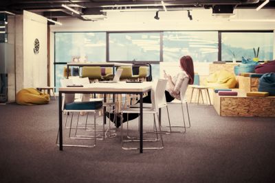 redhead businesswoman using mobile phone at office