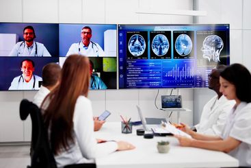 Doctors In Clinic Looking At Brain MRI Scan