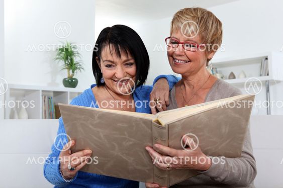 Two women looking through photo album