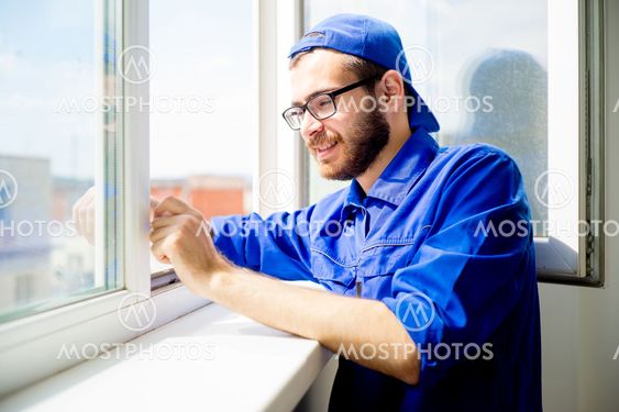 Construction worker installing window