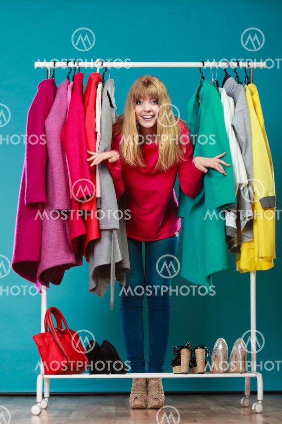 Woman choosing clothes to wear in mall or wardrobe