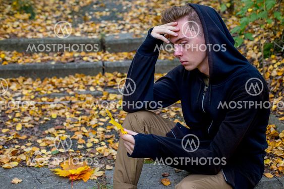 Depressed guy walking in park