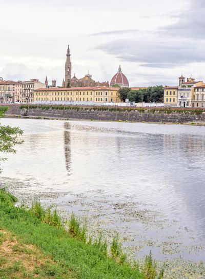 Daylight cloudy day view to Arno river with reflections