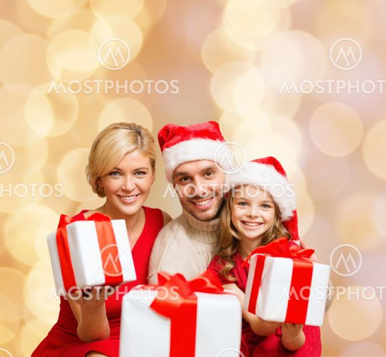 happy family in santa helper hats with gift boxes