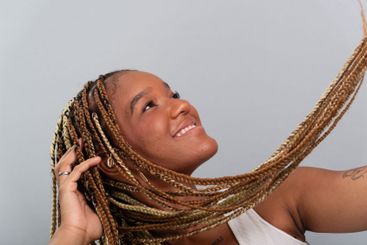 Beautiful brunette woman with braids in her hair,...