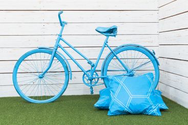 Blue bicycle and two pillows decoration in photostudio
