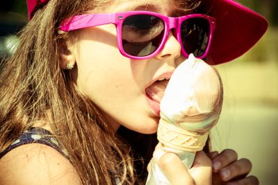Little girl kid eating ice cream. Summer holidays.