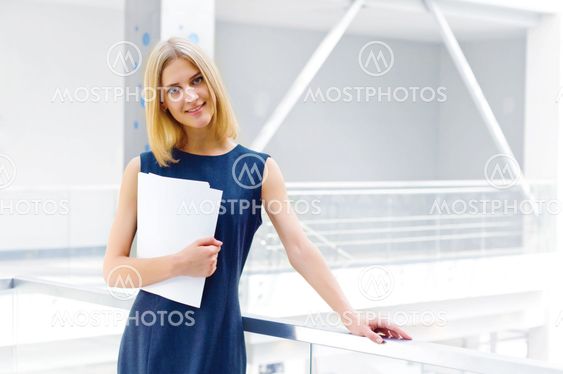 business woman holding reports and looking to the camera