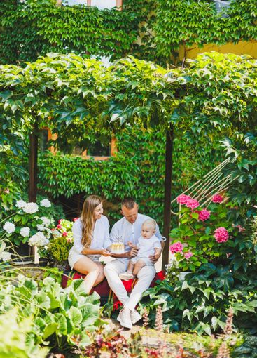 Mom and dad in nature with their one-year-old son...