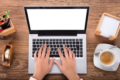Businesswoman Using Laptop On Desk