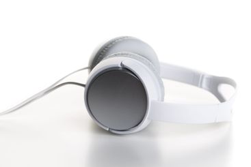 Pair of earphones close up on grey background