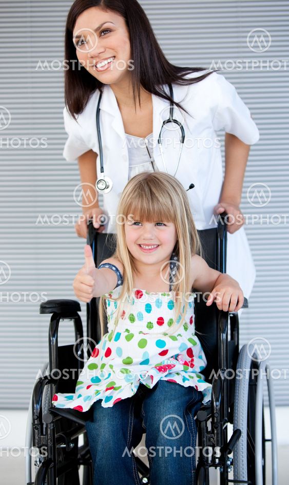 Smiling little girl sitting on the wheelchair