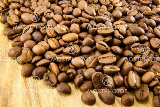 Coffee beans on vintage wooden board