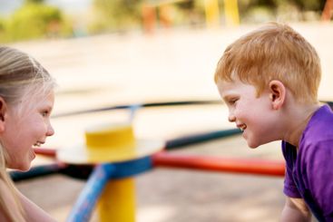 Happy kids, spin and playground with fun childhood on...