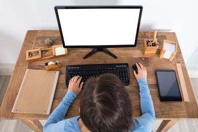 Woman Using Computer At Home